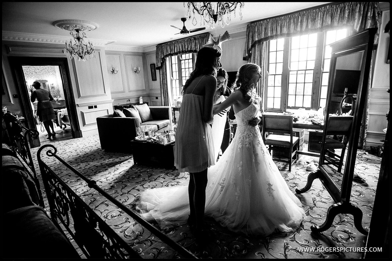 Documentary wedding photographer captures bride in her wedding dress