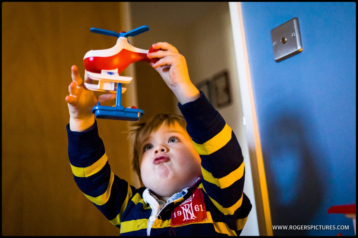 Youngster playing with toy helicopter