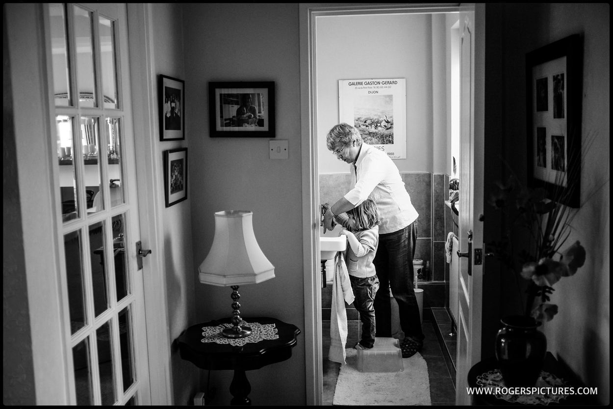 grandma helps granddaughter wash her hands
