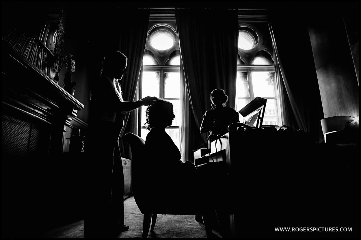 Black and white silhouette of bride preparation