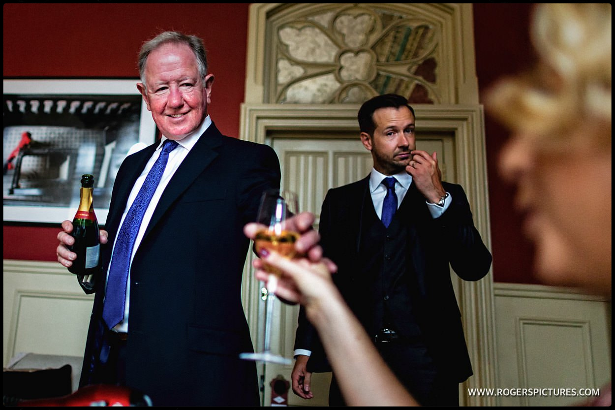 Father of the bride hands out champagne