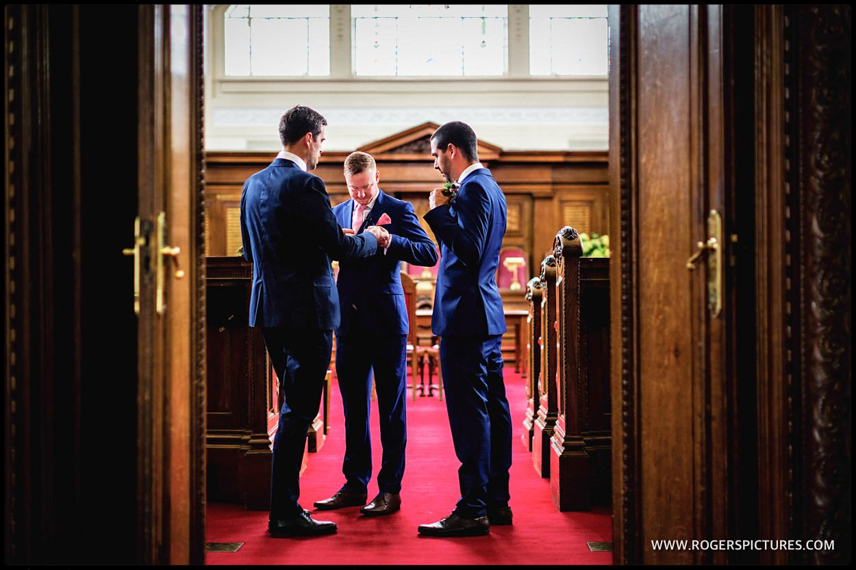 Groom and groomsmen wake in council chamber of Islington town Hall