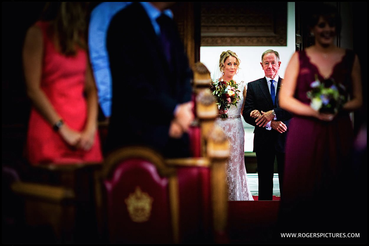 Bride and dad enter council chamber at isn't intangible wedding