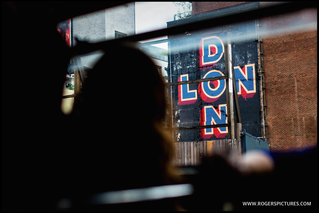 London sign seen through double-decker bus