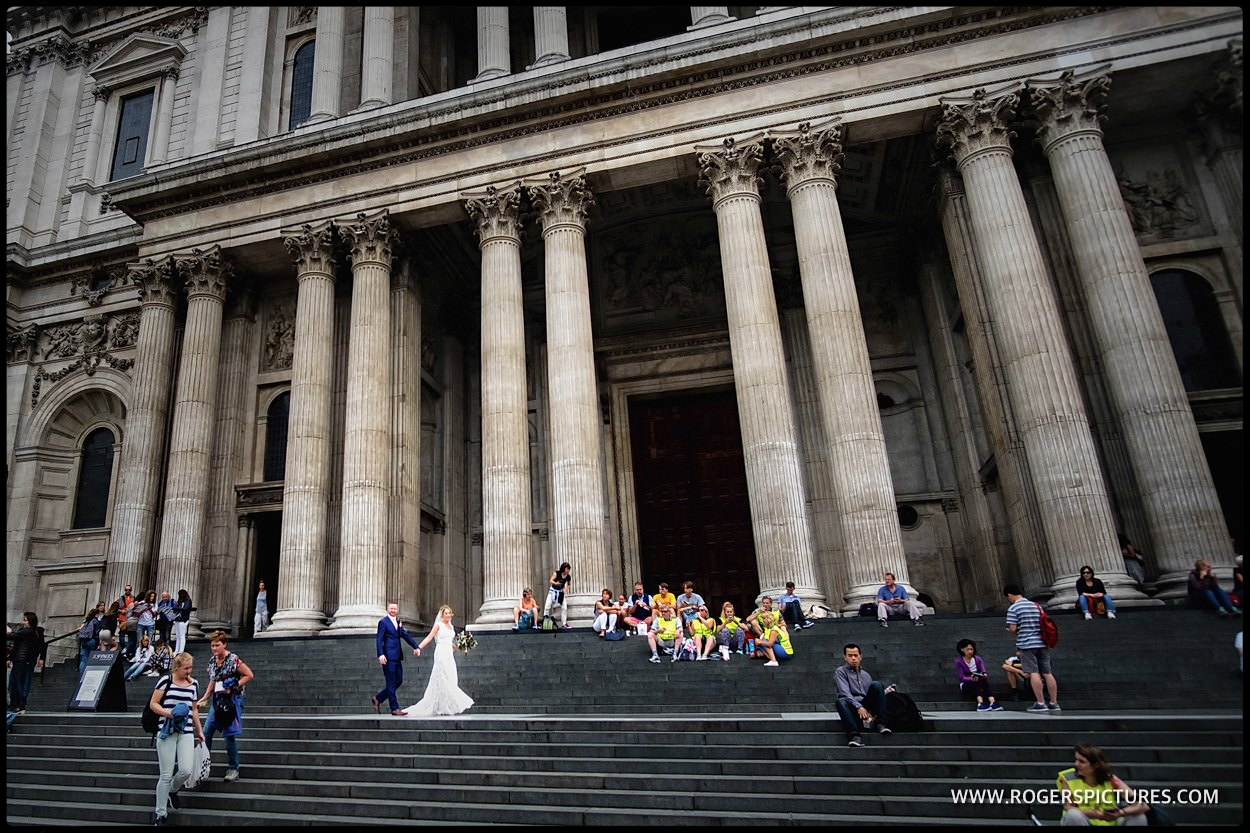 Bride and groom on the steps of St Paul's Cathedral in London