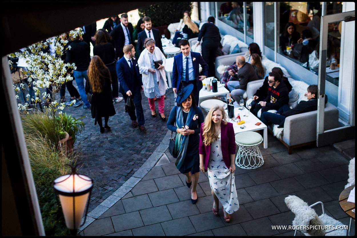 Wedding guests arrive at the Bluebird Cafe in Chelsea