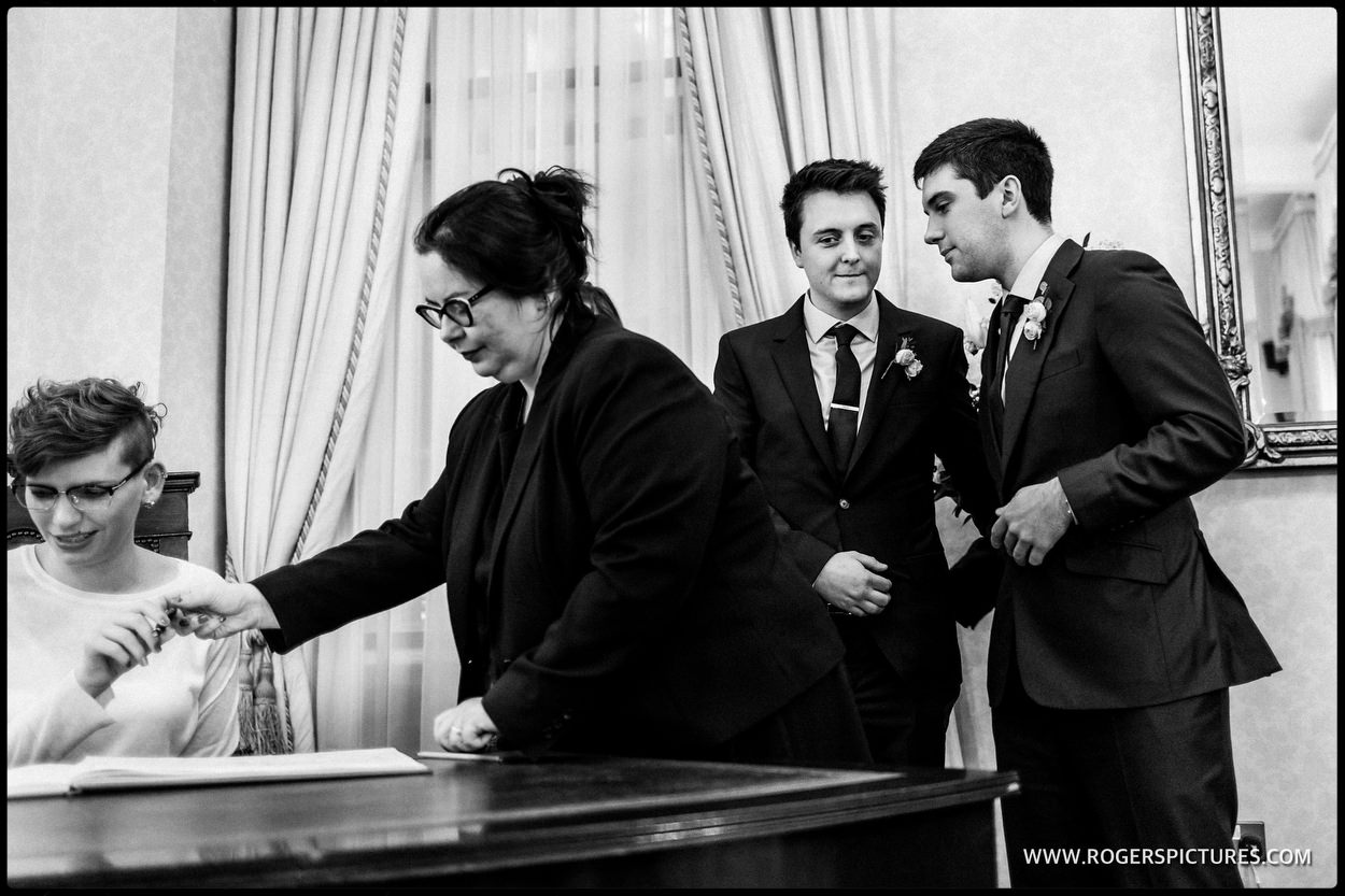 Groom and best man during register signing at Chelsea or Town hall