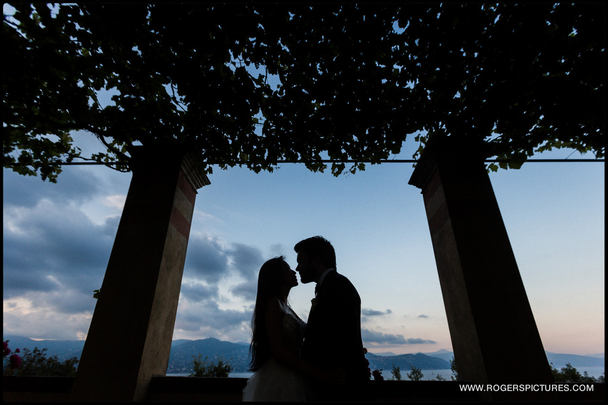 Bride and groom silhouetted in Portofino, Italy