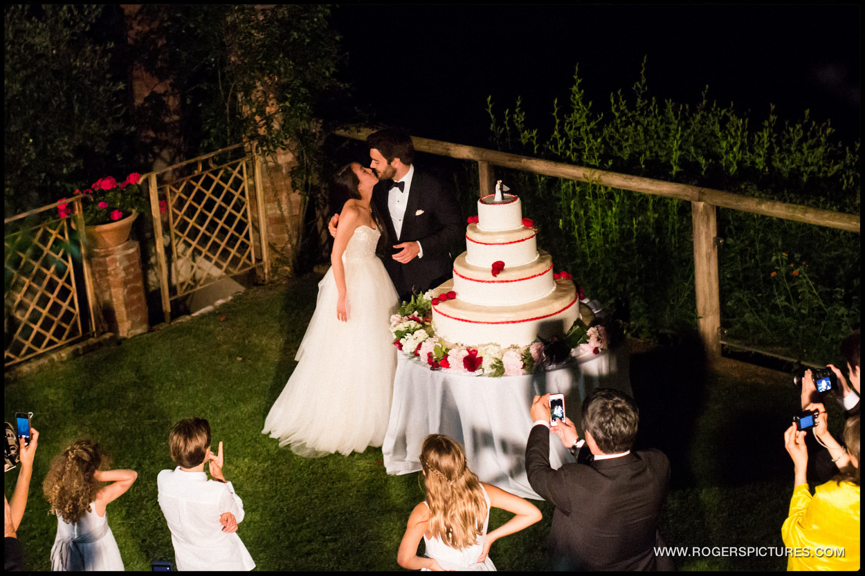 Bride and groom cut wedding cake in Portofino Italy