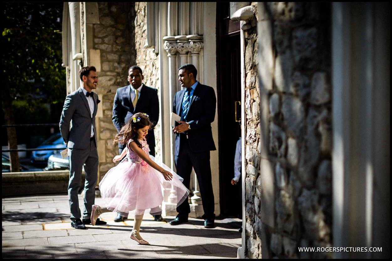 Backlit flower girl at a church wedding