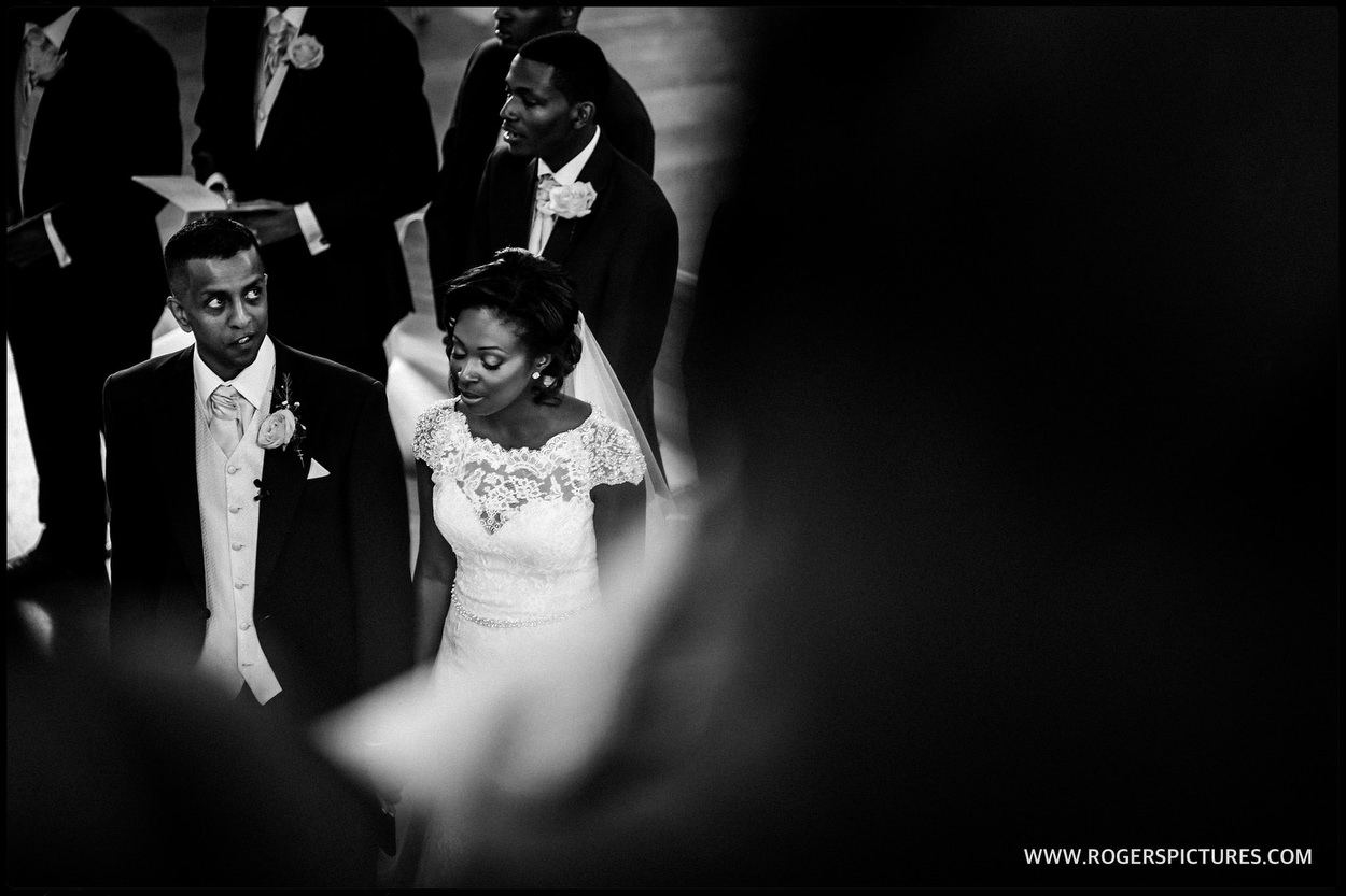 Black-and-white photo of bride and groom during the ceremony