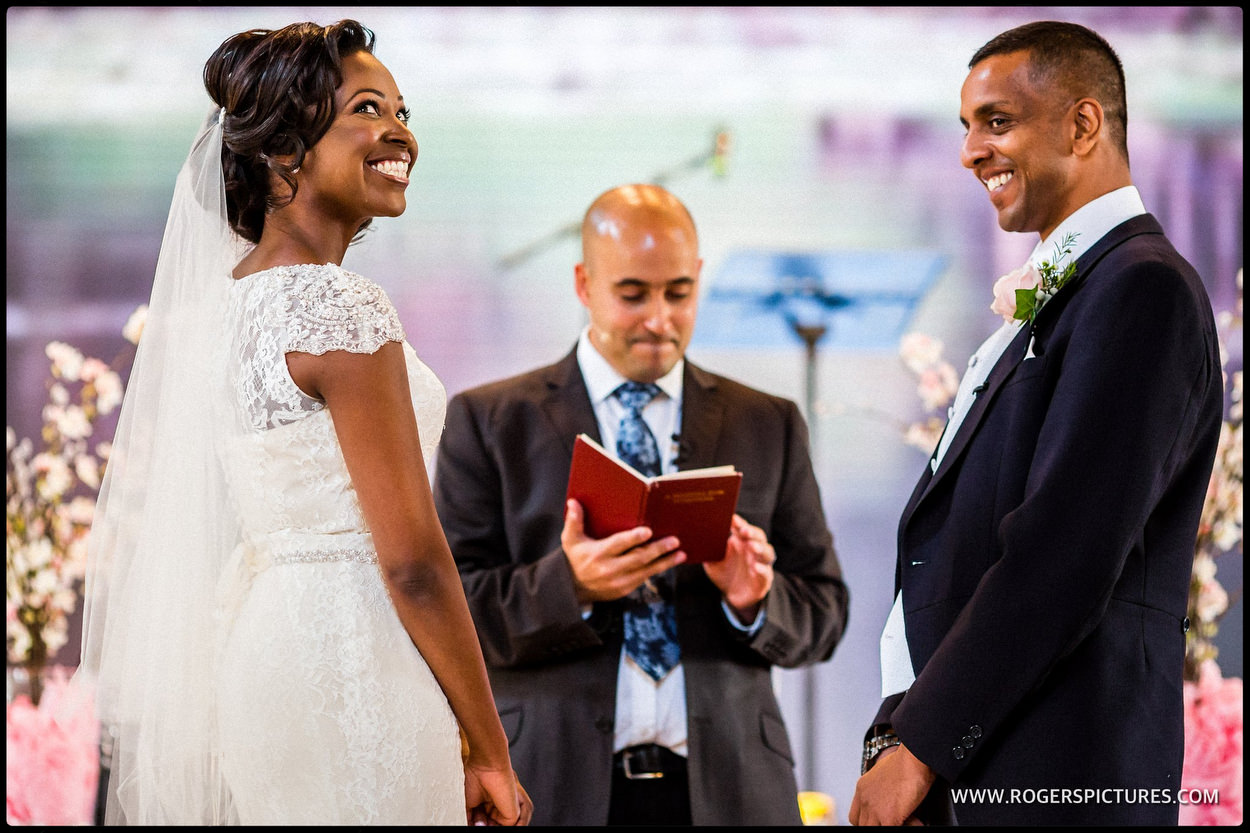 Smiling bride and groom during the vows