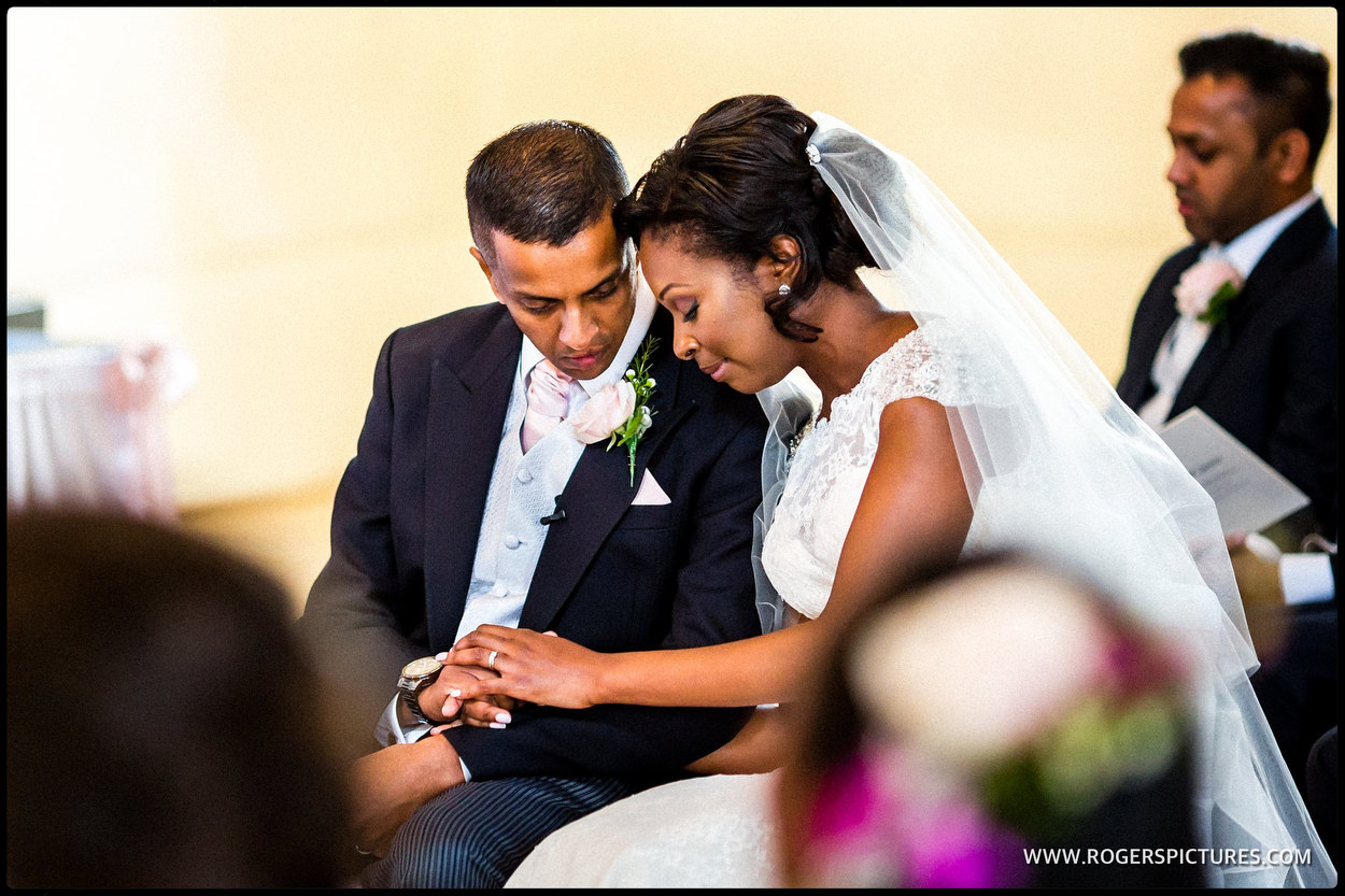 Bride and groom during wedding ceremony in Kensington