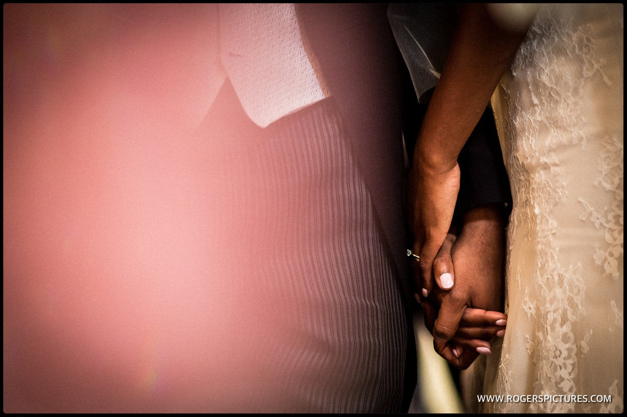 Couple holding hands during wedding ceremony