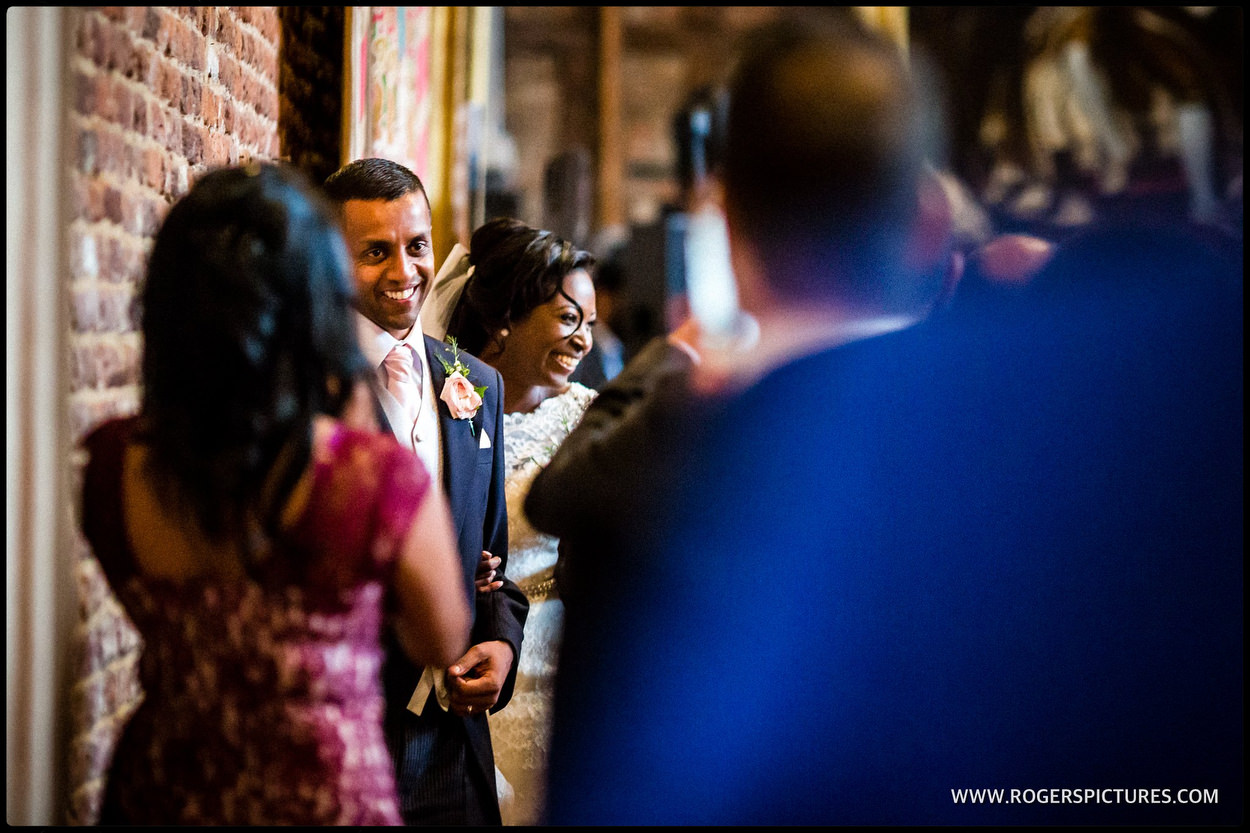 Bride and groom welcome guests in the old Palace