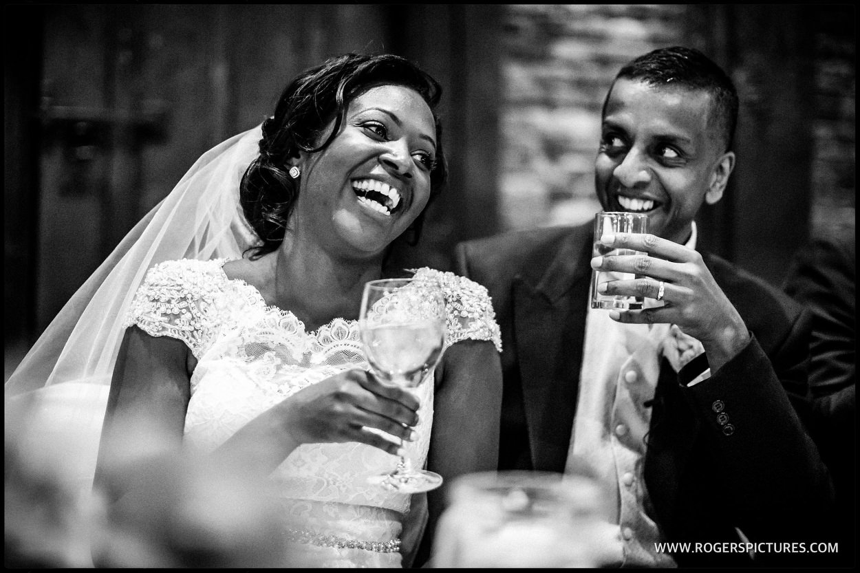 Bride and groom listen to speeches at Hertfordshire wedding