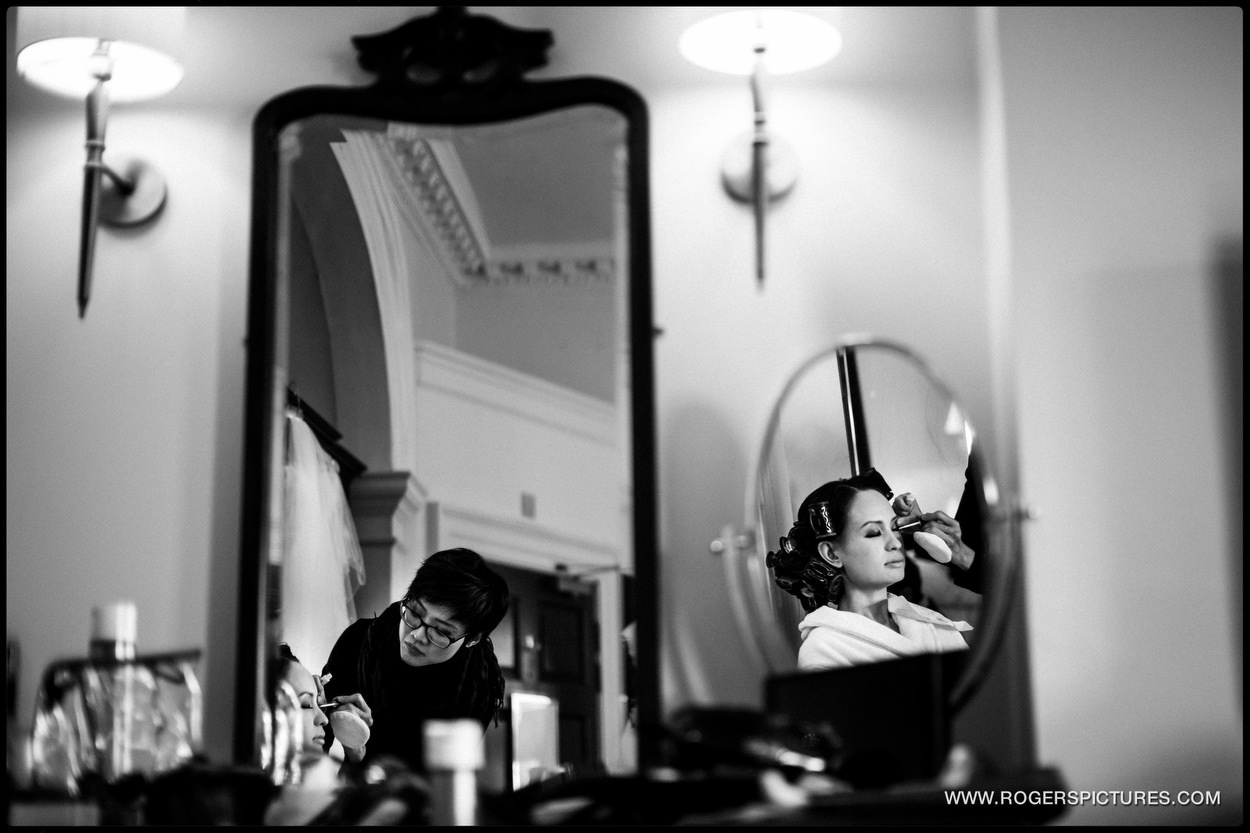 Reflection of a bride in an oval mirror
