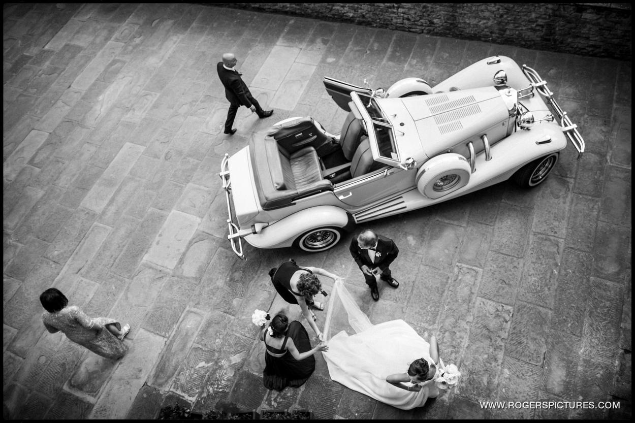 Aerial view of bride and car at a destination wedding in Italy