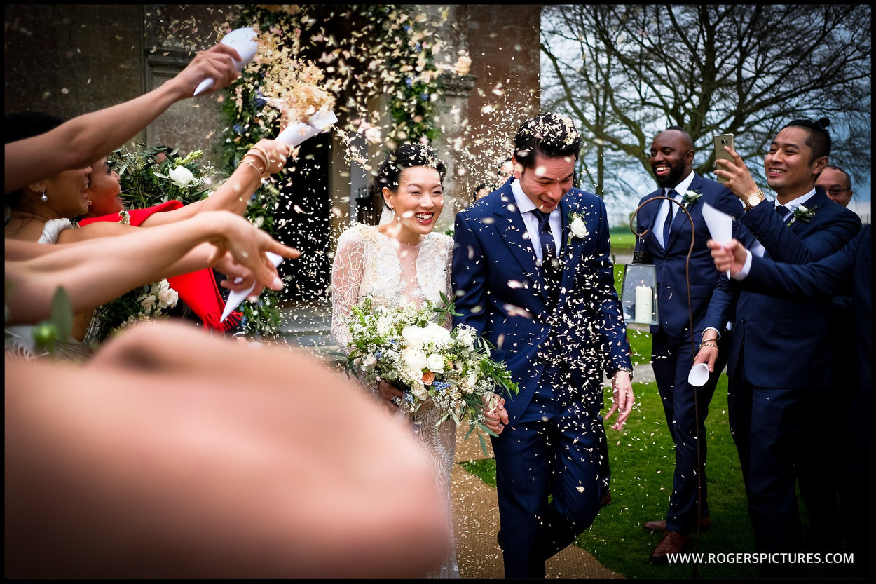 Bride and groom showered in confetti