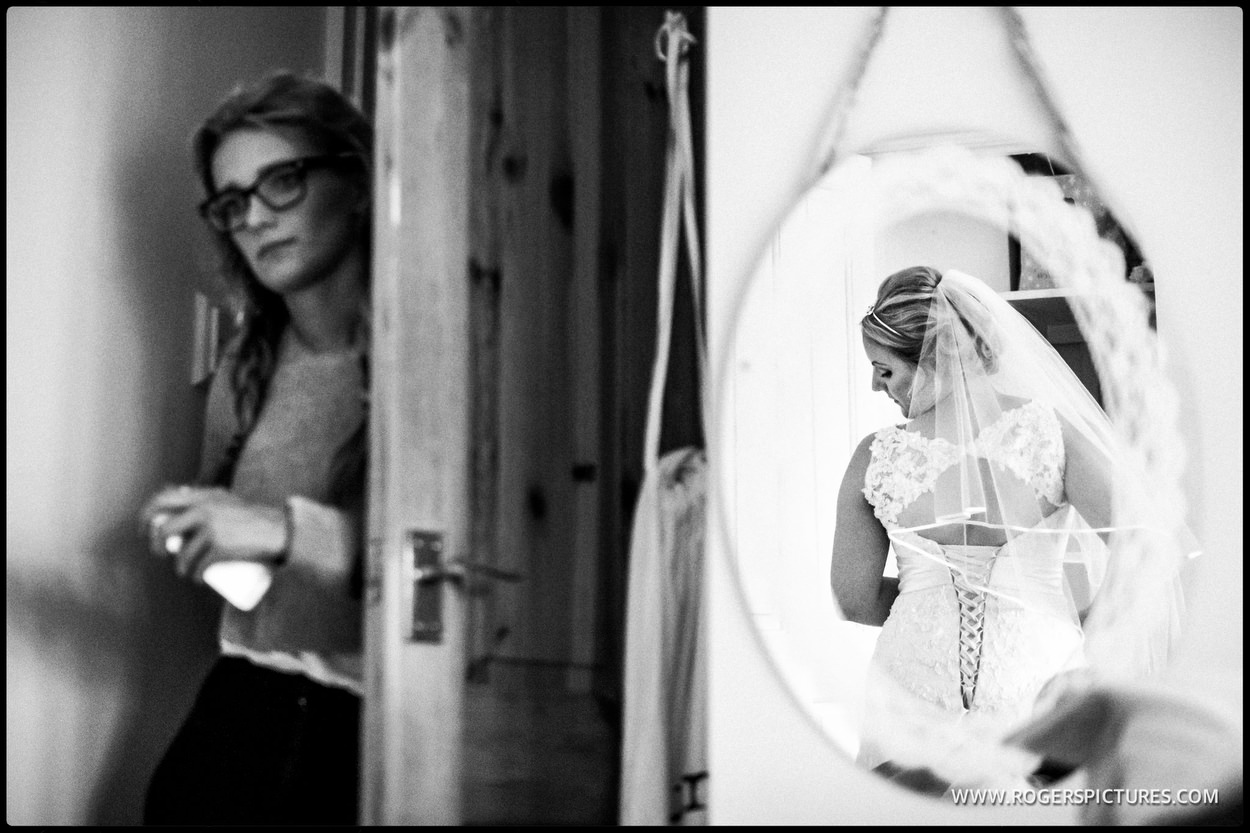 Bride reflected in an oval mirror