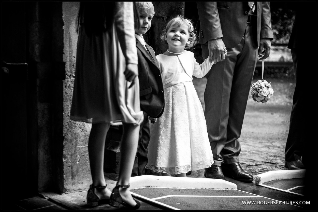 Children wait in church doorway for brides arrival