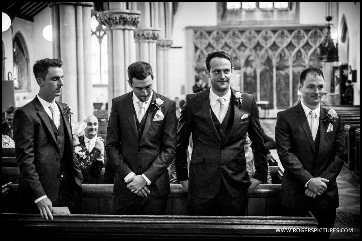 Groom and groomsmen wait nervously in church