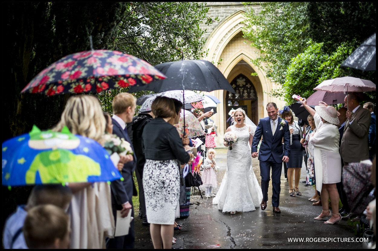 Husband and wife leave church in the rain