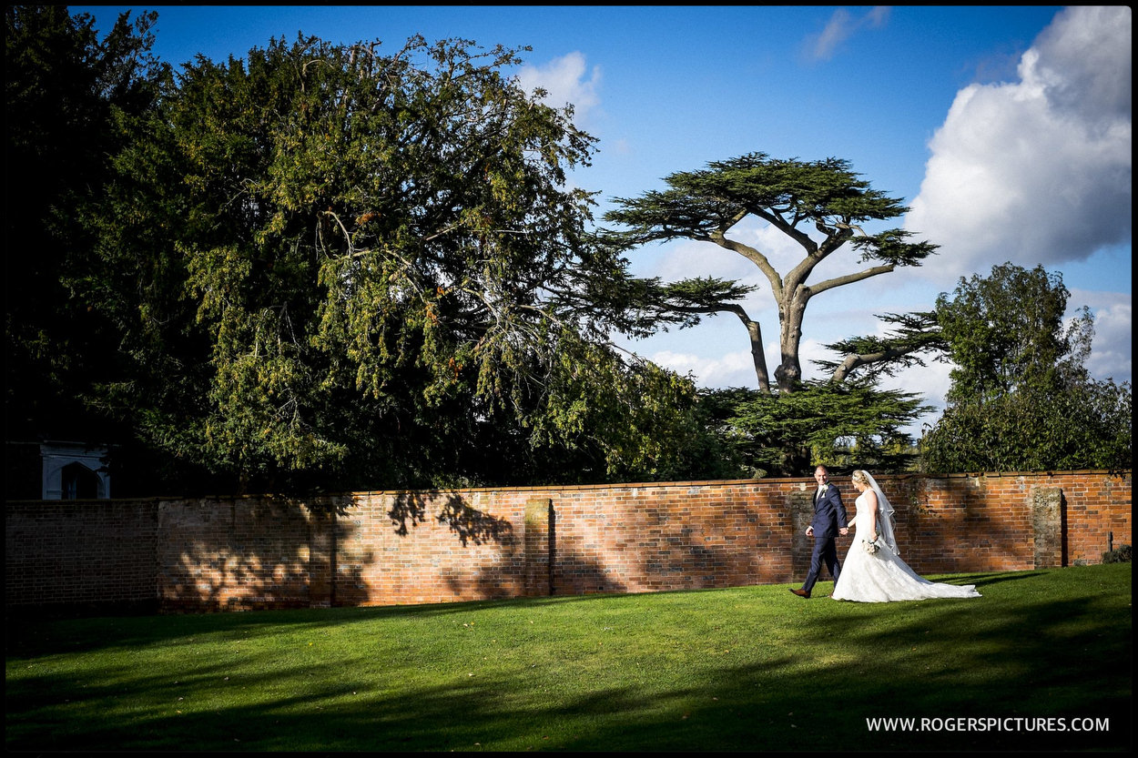 Couple walking through the garden after wedding ceremony