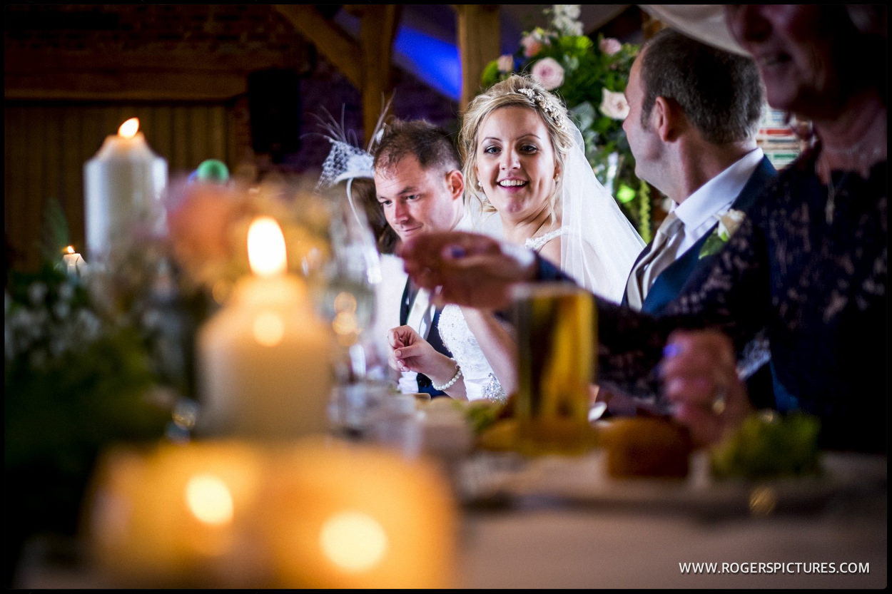 Bride and groom sitting at the top table at a wedding