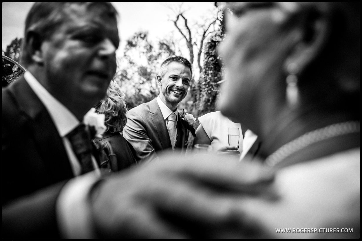 Groom being congratulated after wedding ceremony