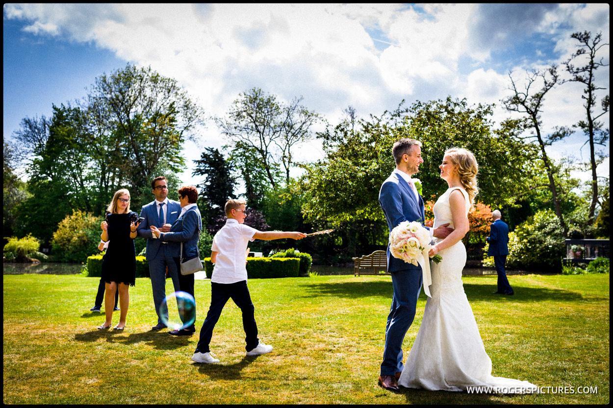 Bride and groom embrace in hotel gardens