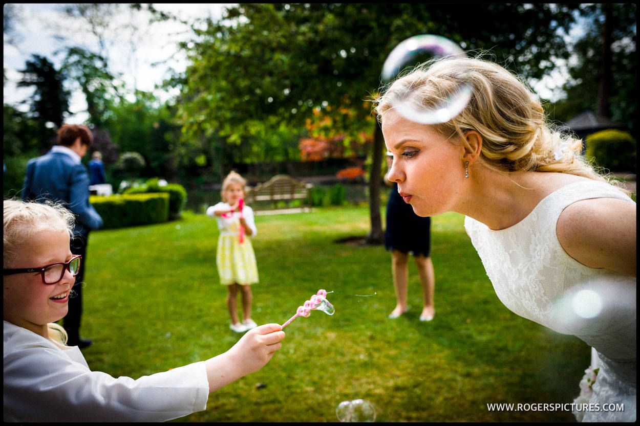 Photo of bride blowing bubbles