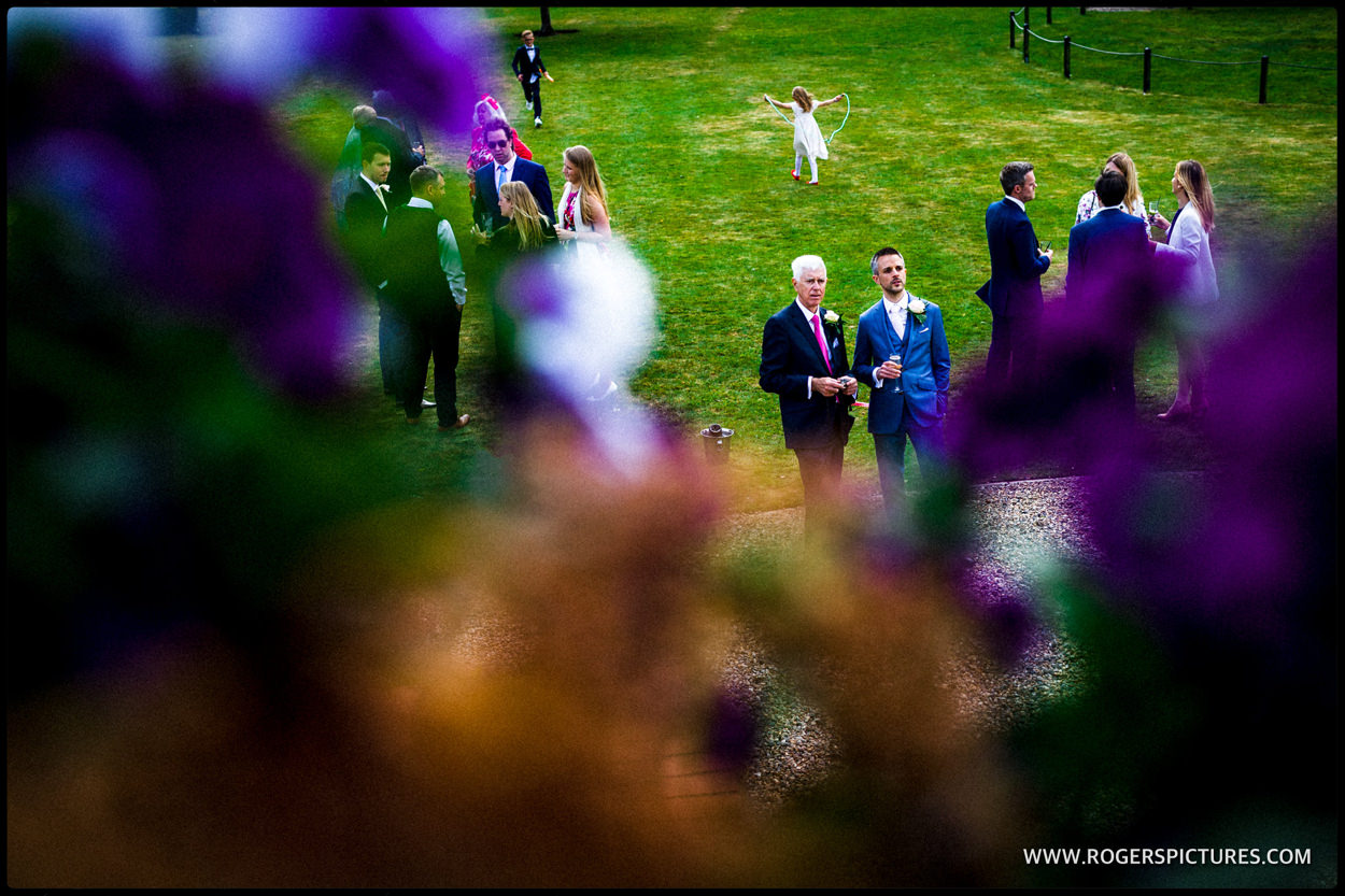 Groom and father in the hotel gardens after a wedding