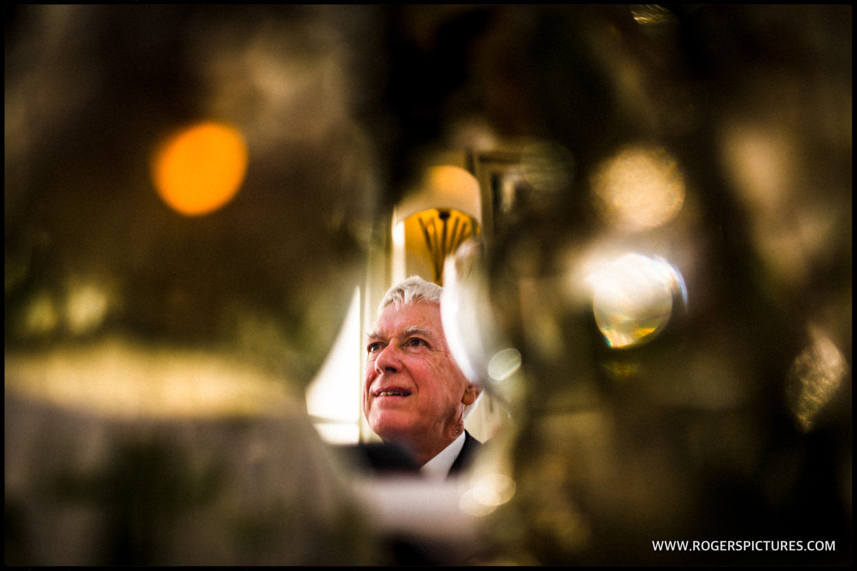 Father of the groom reflected in a mirror during speeches