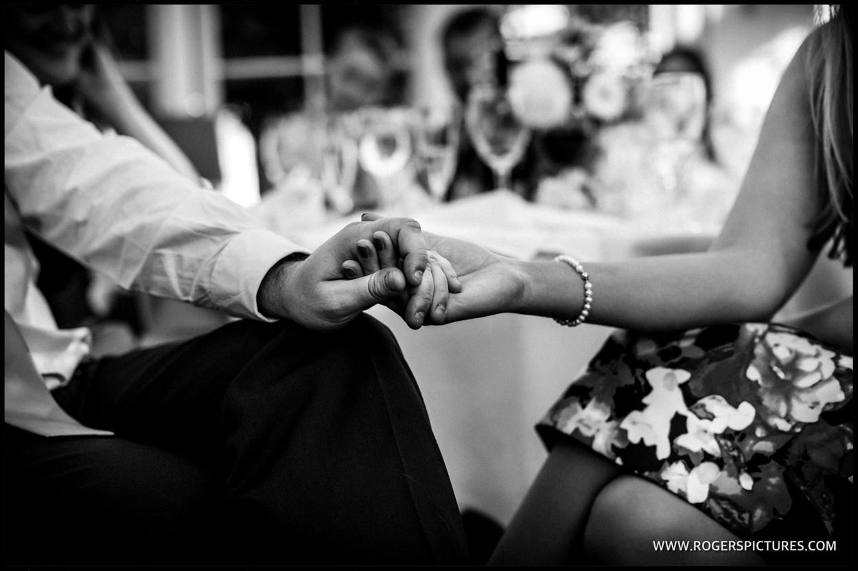 Guests hold hands during the after dinner wedding speeches