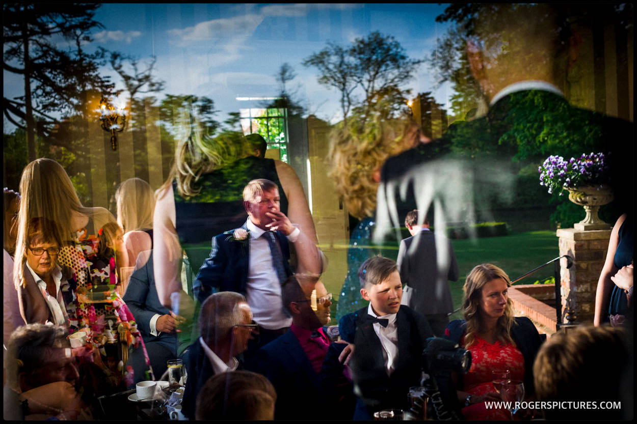 Complex scene through window reflection at a wedding in St Albans