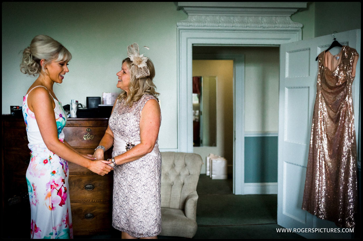 Bride and mother greet during wedding preparations
