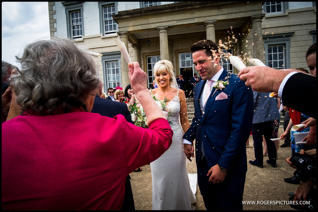 Couple and confetti at Buxted Park