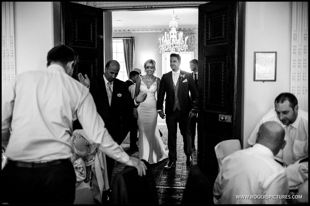 Couple enter wedding breakfast