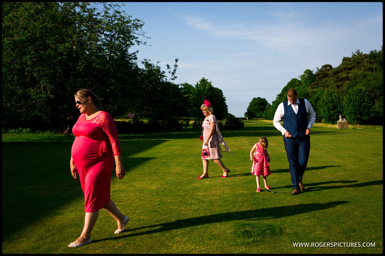 Family walk in the grounds at Buxted Park after wedding