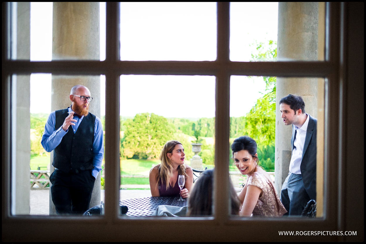 Friends framed in windowpanes during wedding