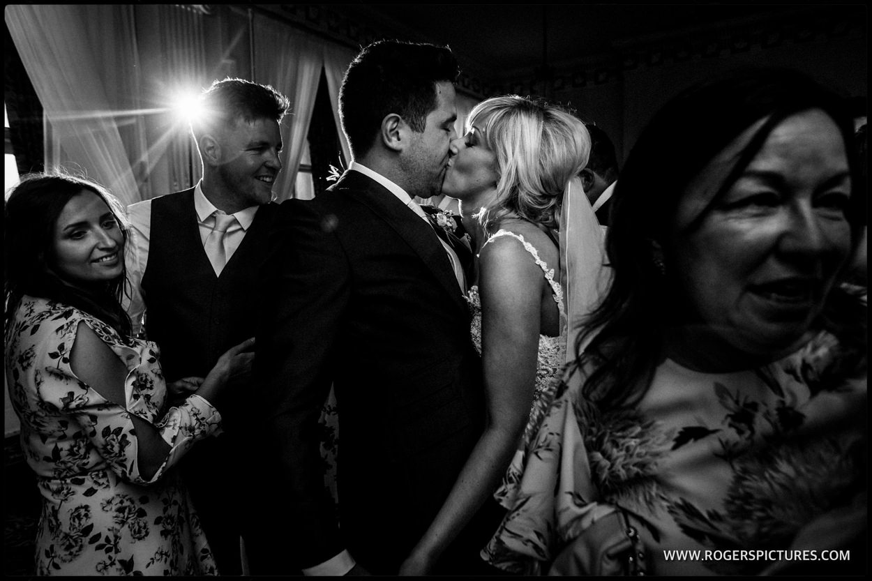 Husband and wife kiss on the dancefloor