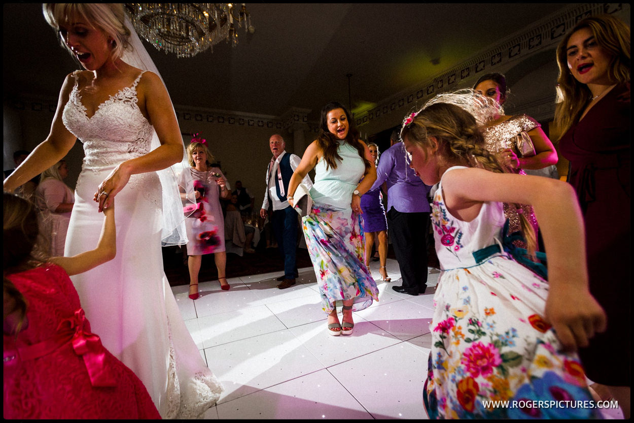 Friends dancing at Buxted Park wedding