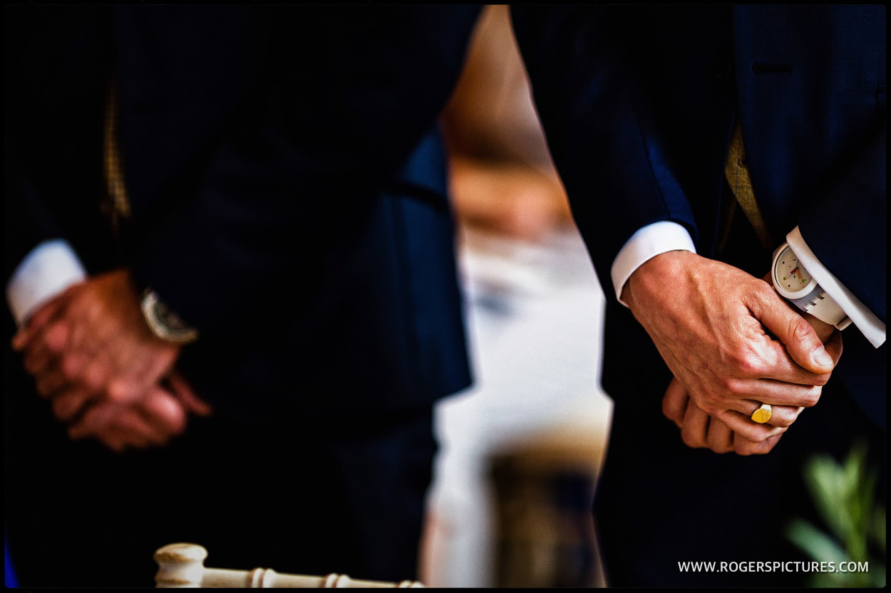 Detail of grooms hands at wedding