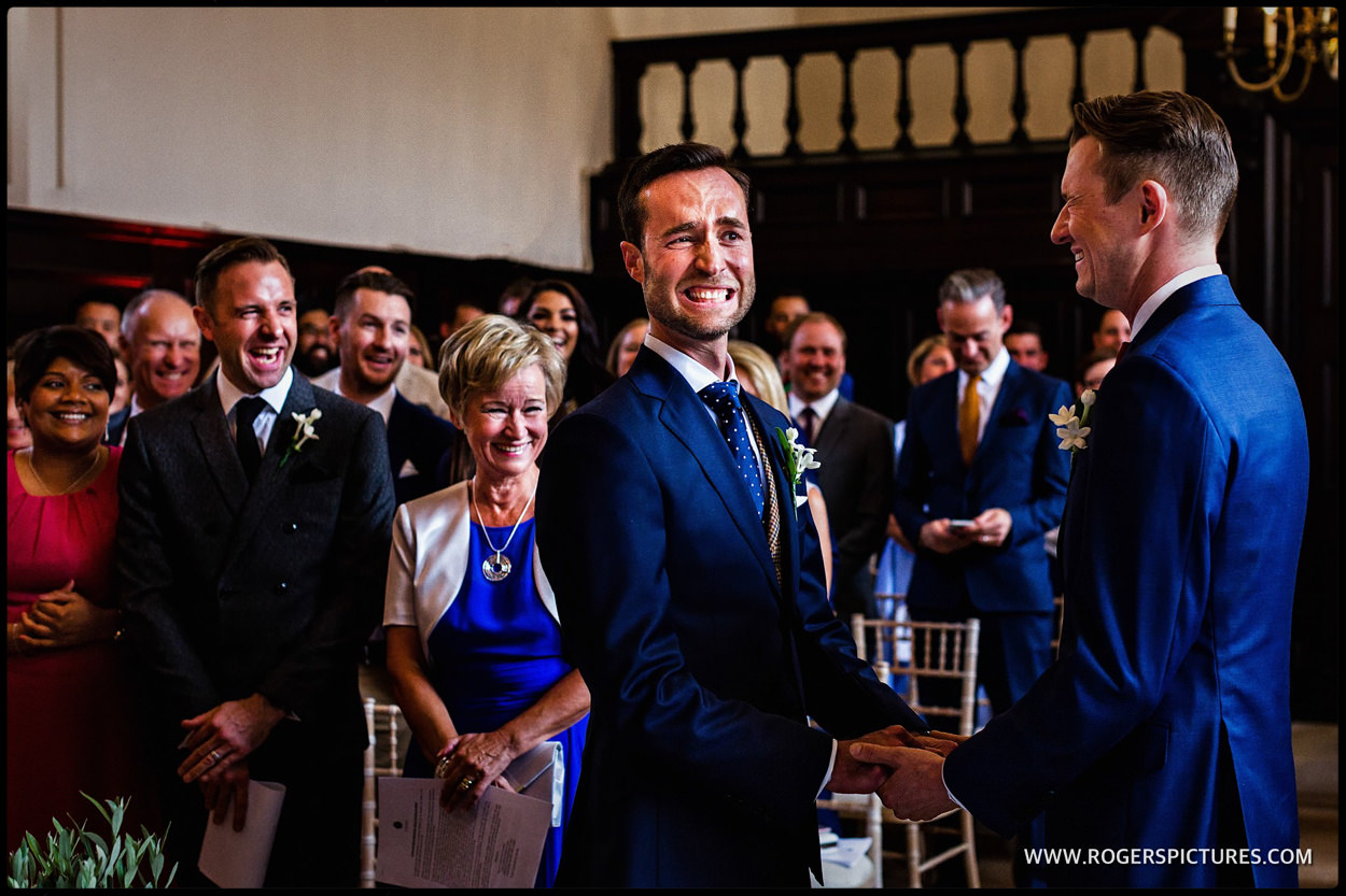 Smiling grooms during wedding ceremony