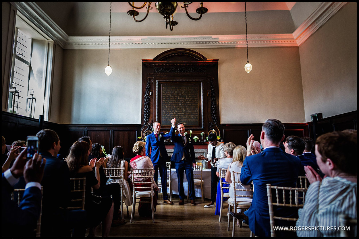 Happy grooms after getting married in the great Hall at Fulham Palace