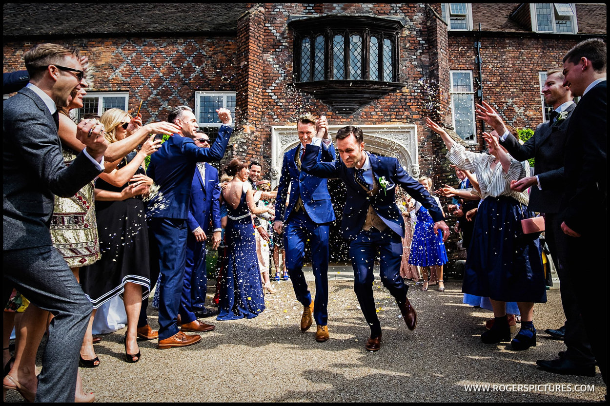 Grooms in confetti at Fulham Palace