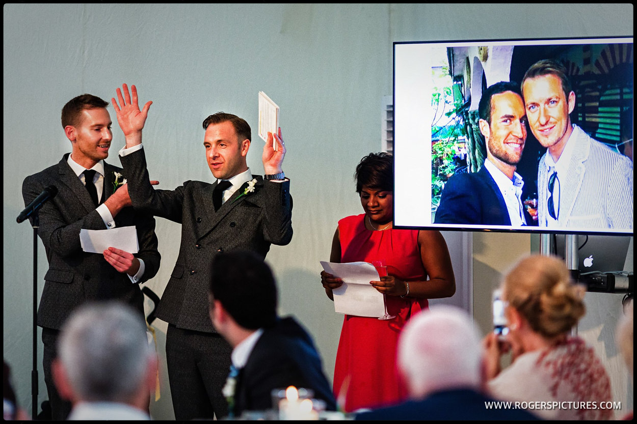 Two grooms during speeches at same-sex wedding