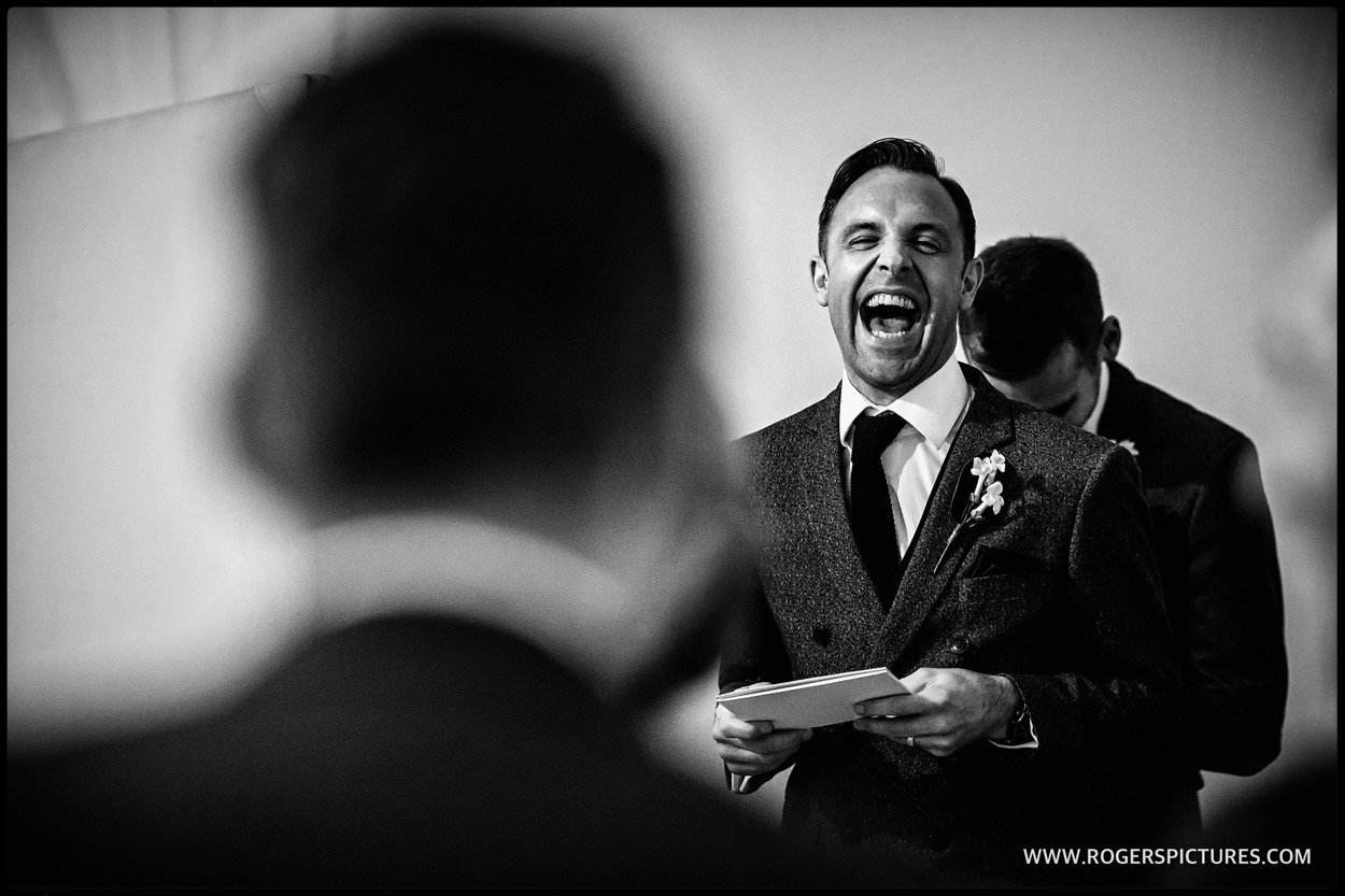 Laughing best man delivers speech