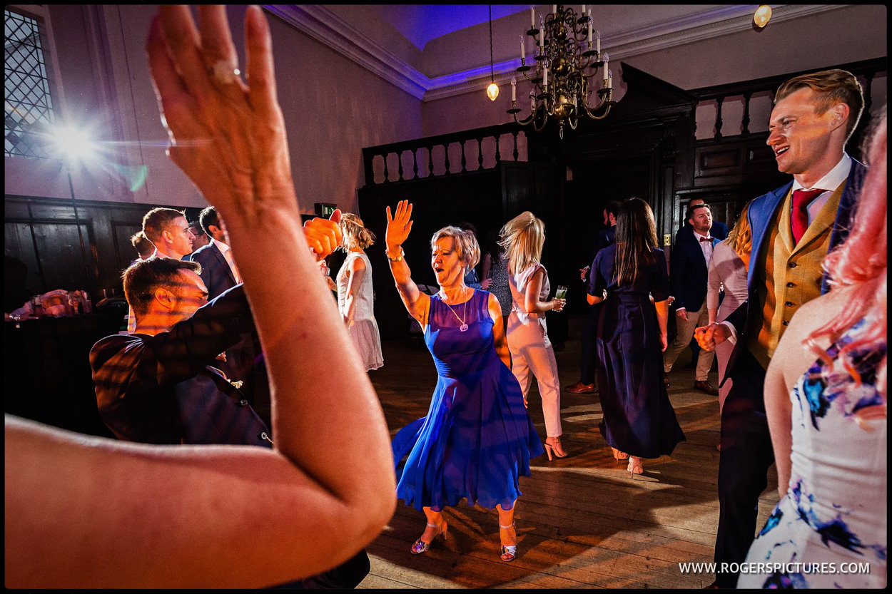 Mother of the Groom in blue dress dancing at a wedding